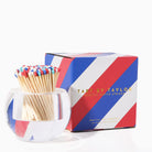 Match striker with colorful matches and striped packaging on a white background