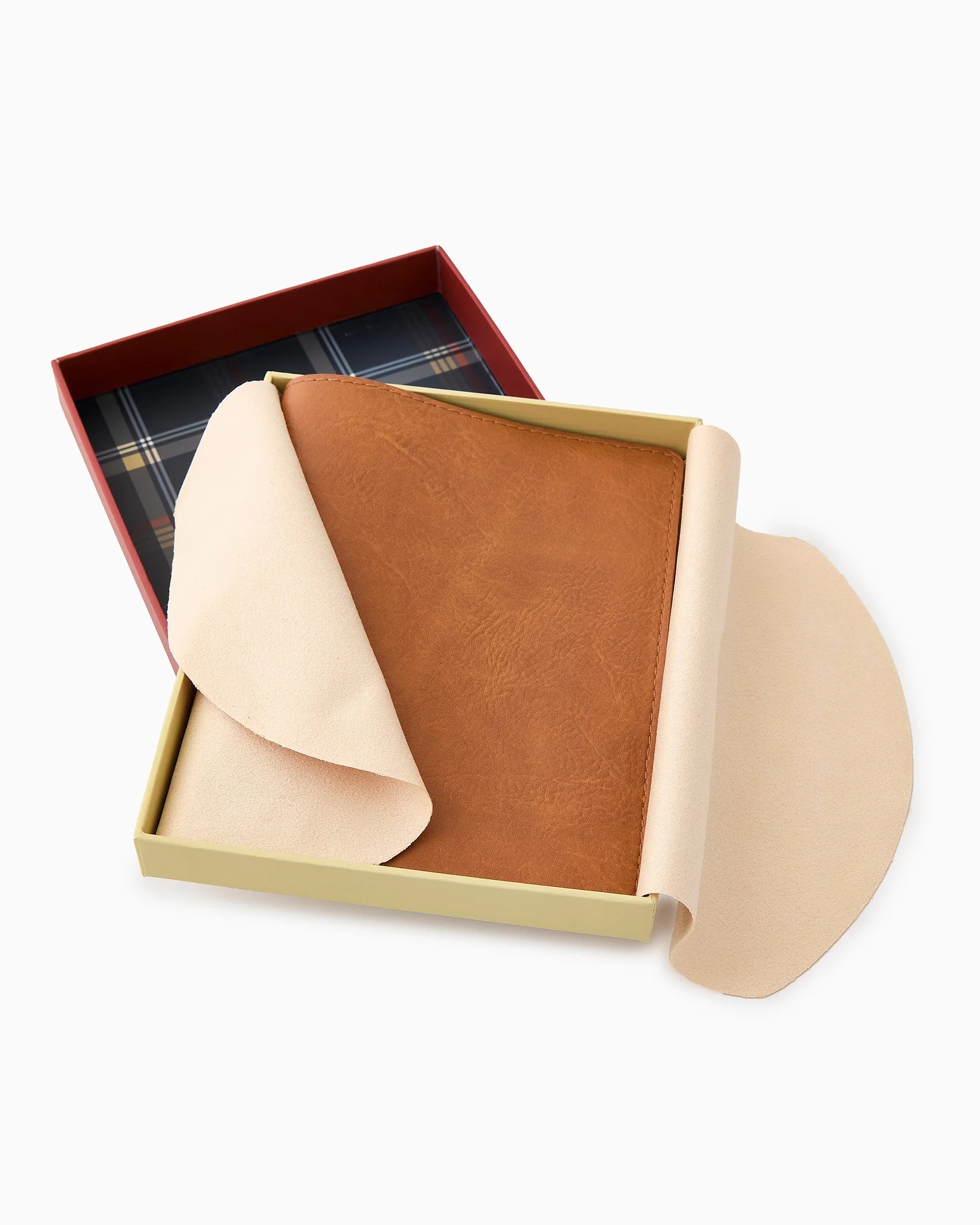 Brown leather wallet with beige interior in an open box on a white background