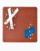 Red game board with cards, dice, and game pieces on a white background