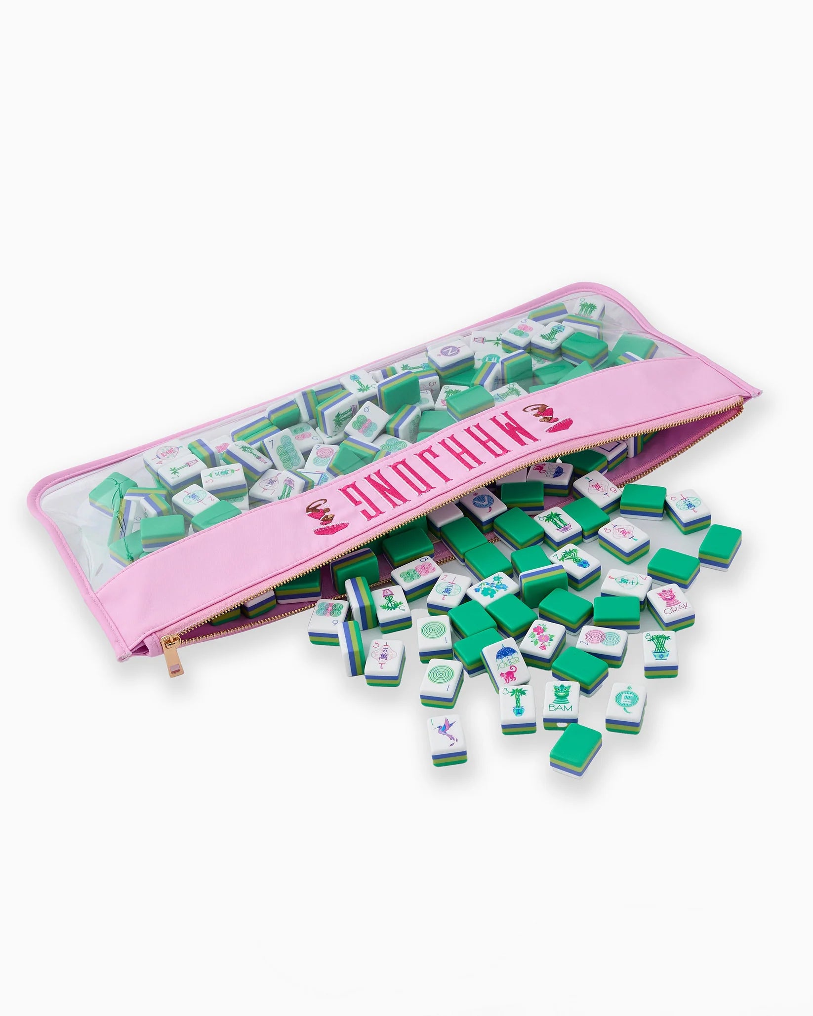 Green and white game pieces with pink carrying case on a white background