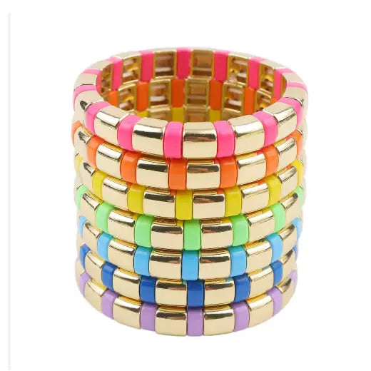 Stack of colorful bangles with gold accents on a white background