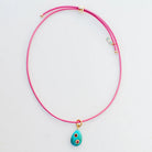 Pink necklace with a turquoise pendant on a light gray background