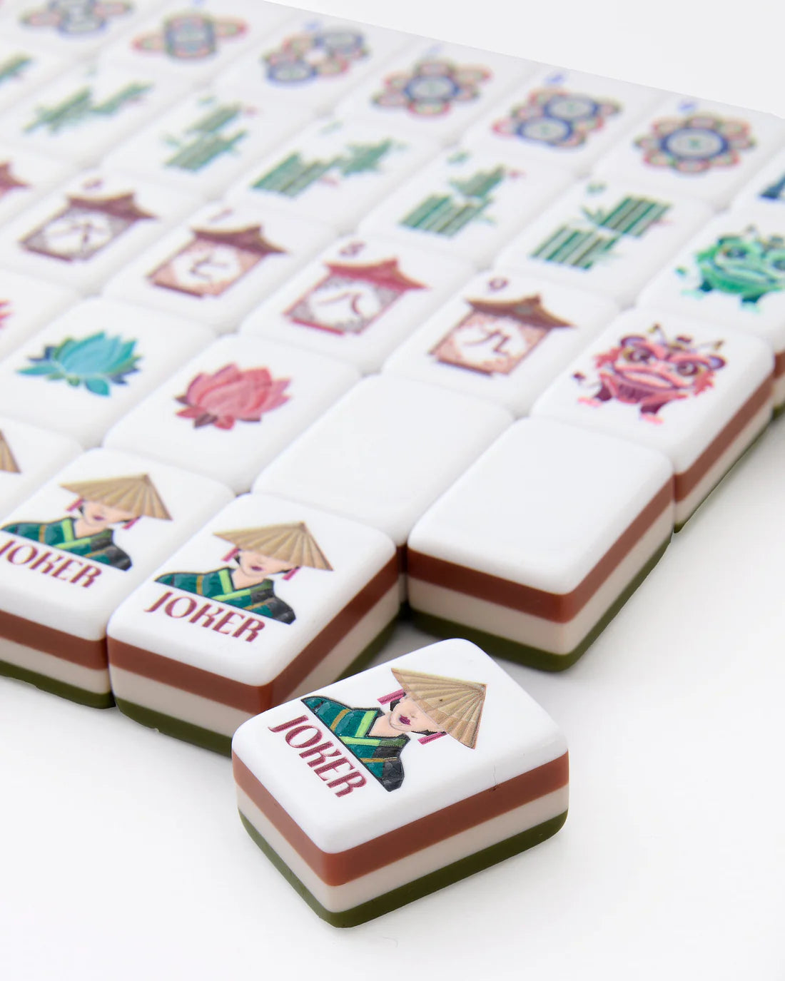 Mandarin oranges with decorative labels featuring characters and symbols on a white background