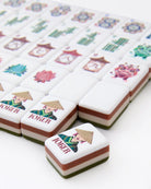 Mandarin oranges with decorative labels featuring characters and symbols on a white background