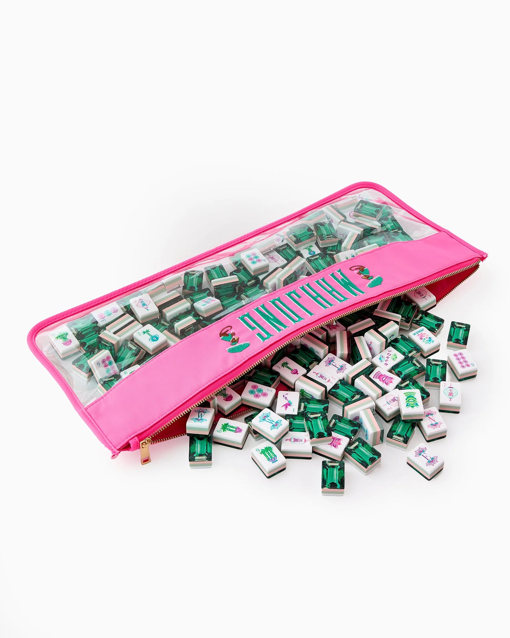 Pink travel case with green and white game pieces on a white background
