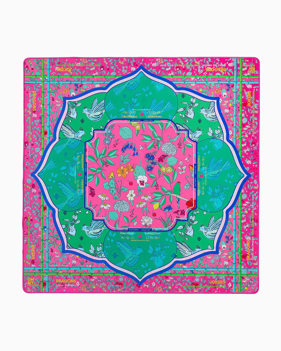 Colorful decorative mat with floral patterns and green border on a pink background