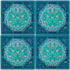 Four matching coasters with a floral design on a blue background