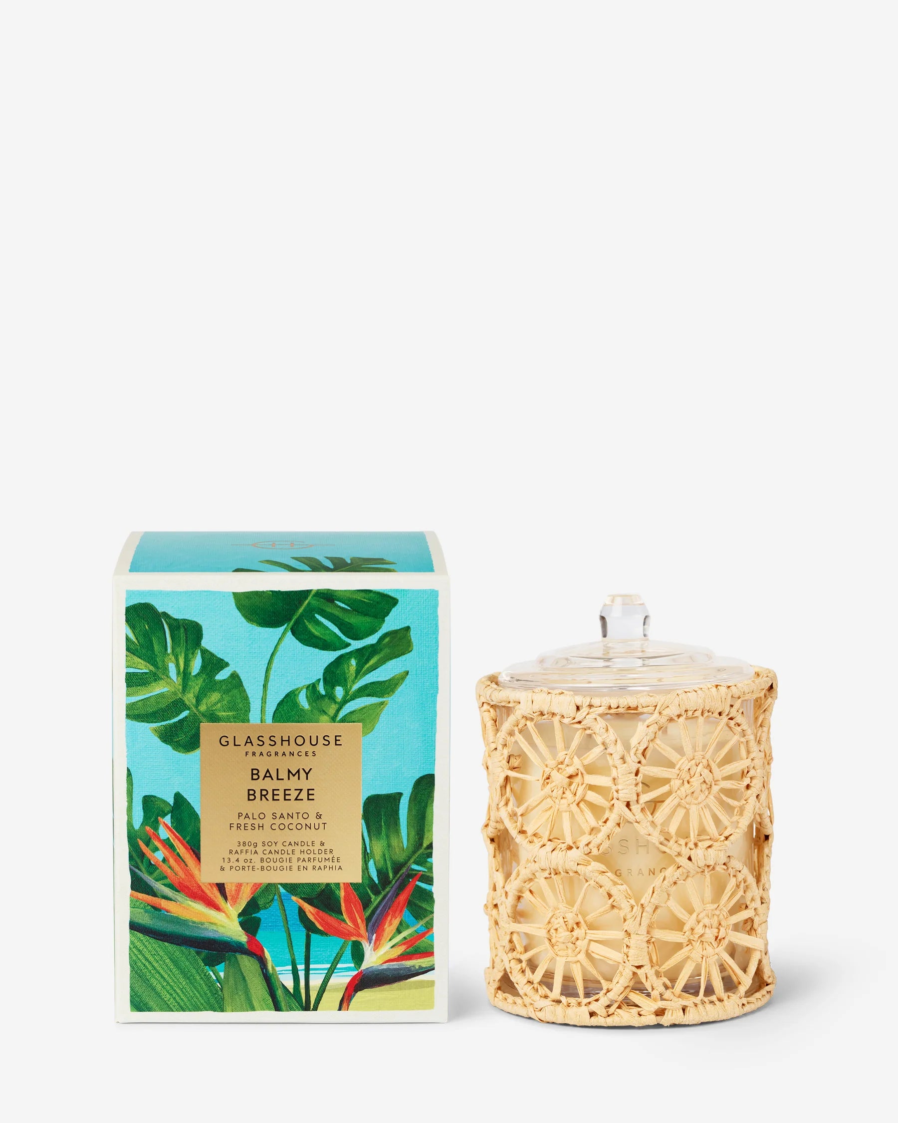 Candle with decorative wicker lid and 'Glasshouse' branded packaging on a white background