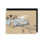 Card with a drawing of a couple in a convertible car with 'Just Married' sign, on a brown background.
