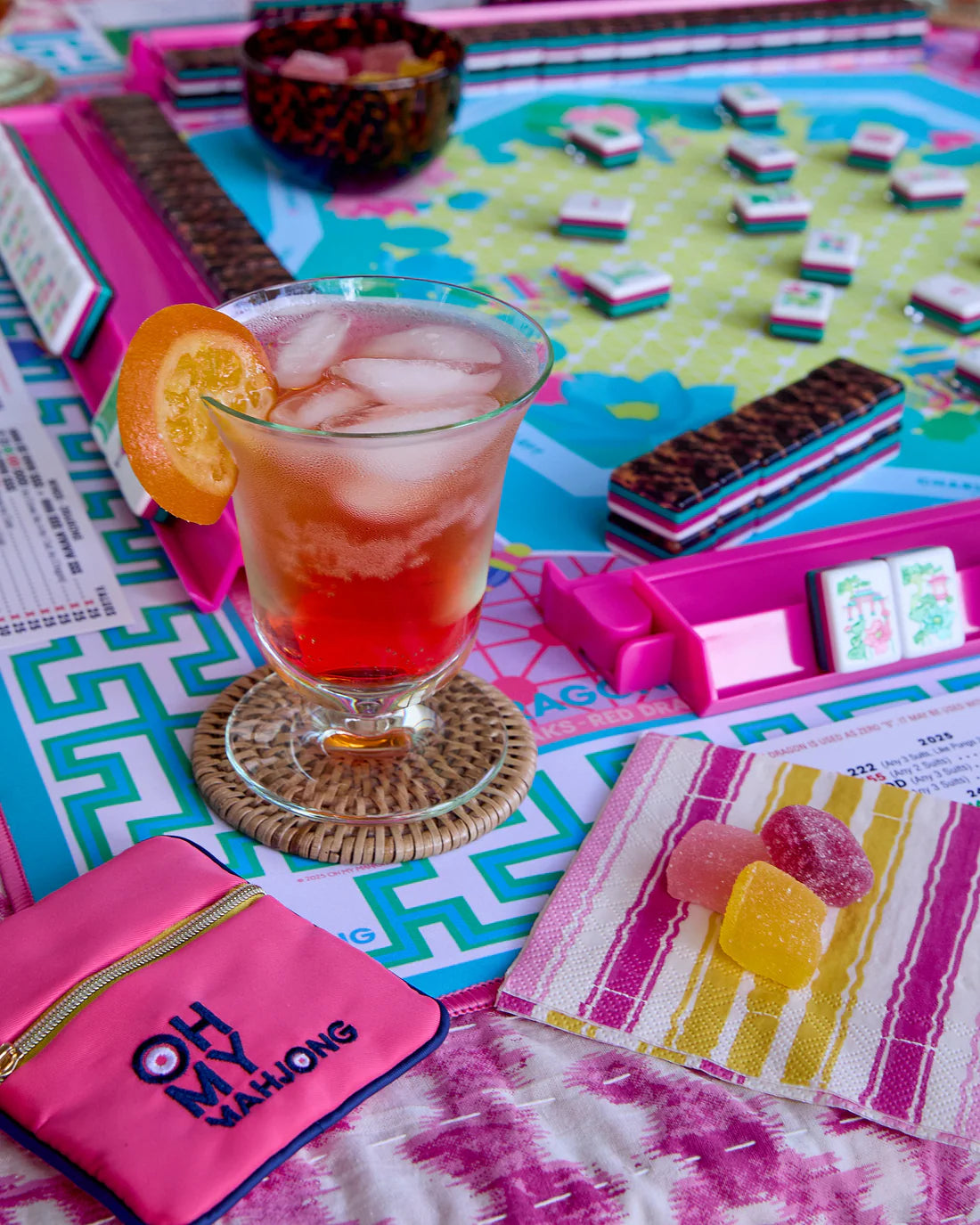 Colorful board game with a drink and snacks on a table