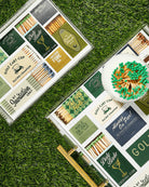 Matches with decorative labels on a grassy surface