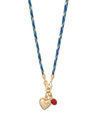 Necklace with heart-shaped pendant and red bead on a white background