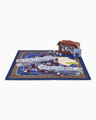 A mahjong set displayed on a decorative blue and gold mat, with several clear acrylic racks holding tiles, a brown carrying case, and game accessories arranged on a white background.