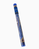 A rolled-up blue and gold patterned mat or rug shown diagonally on a plain white background. The top cap is blue, and the roll features decorative gold and white line art on a blue base.
