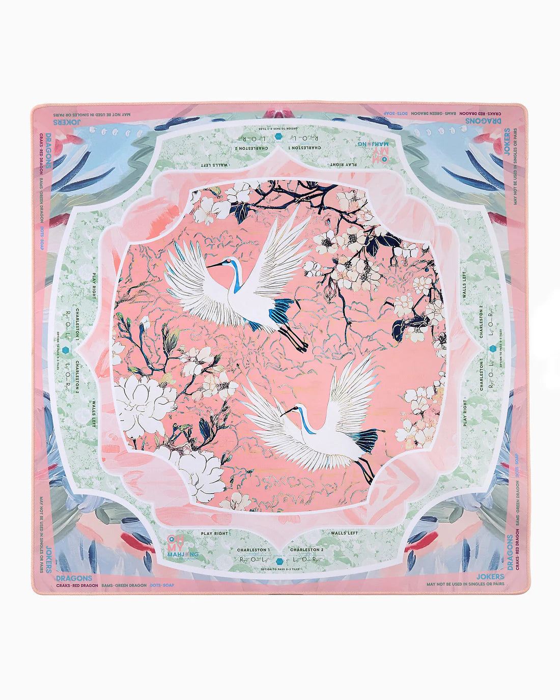 Decorative placemat with cranes and floral design on a pink background