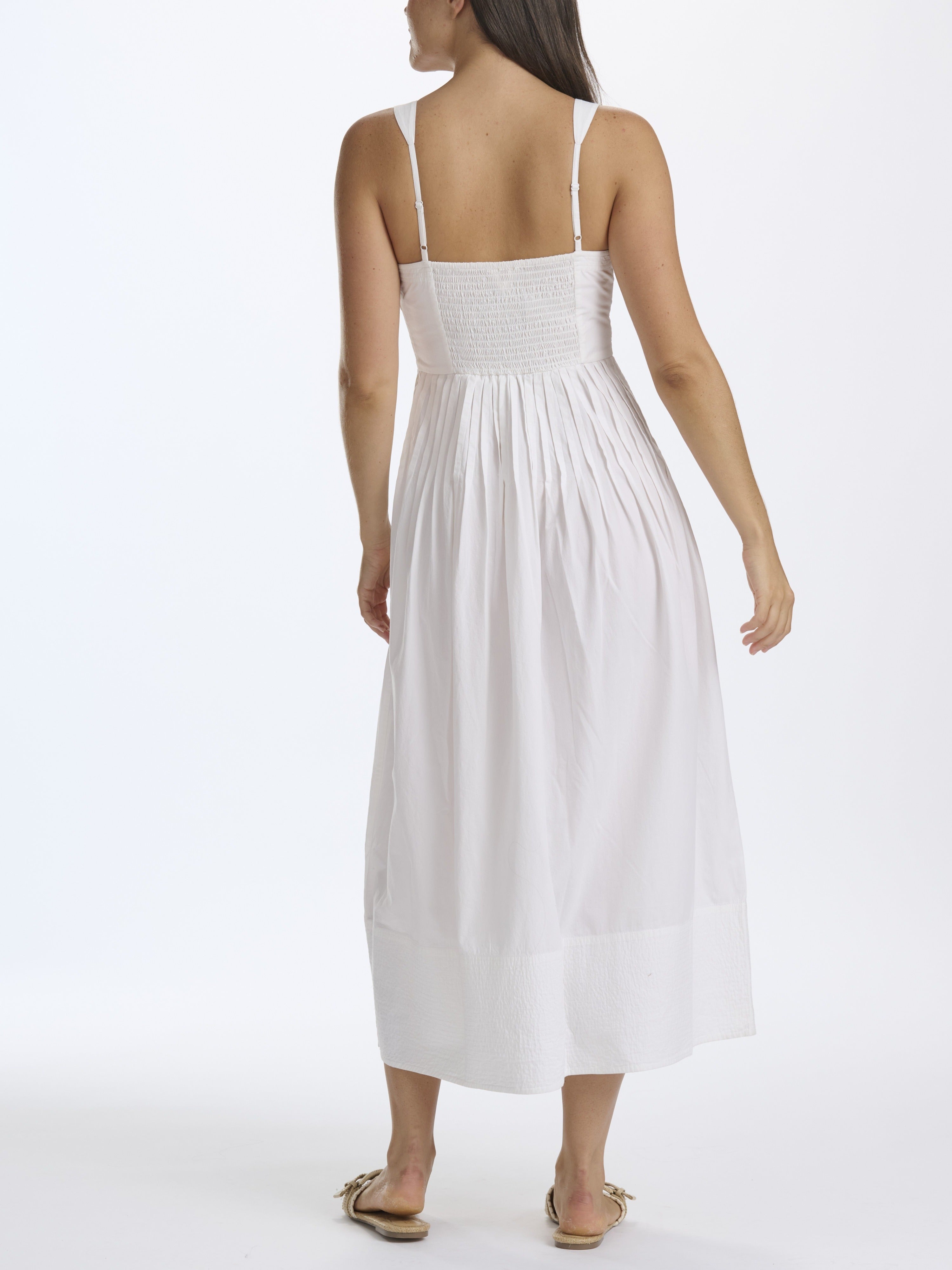 Woman wearing a white dress on a white background