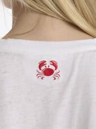 White shirt with a red crab design on the back