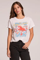 Woman wearing a white t-shirt with a graphic design on a plain background