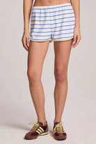Person wearing blue and white striped shorts on a plain background