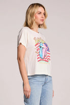 Woman wearing a t-shirt with a colorful graphic design on a plain background
