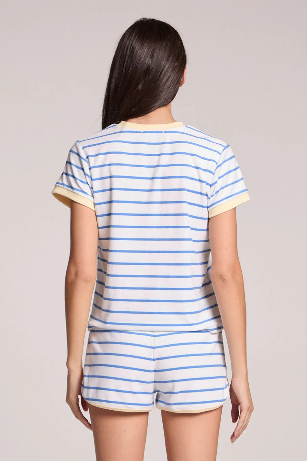 Person wearing a blue and white striped outfit on a plain background