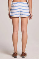 Person wearing blue and white striped shorts on a plain background