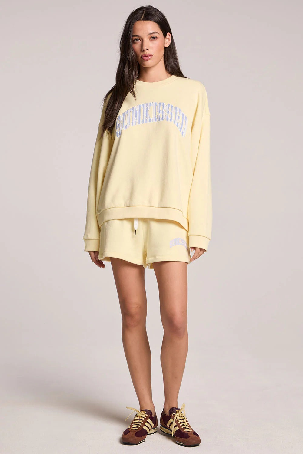 Woman wearing a yellow outfit with a white background
