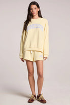 Woman wearing a yellow outfit with a white background