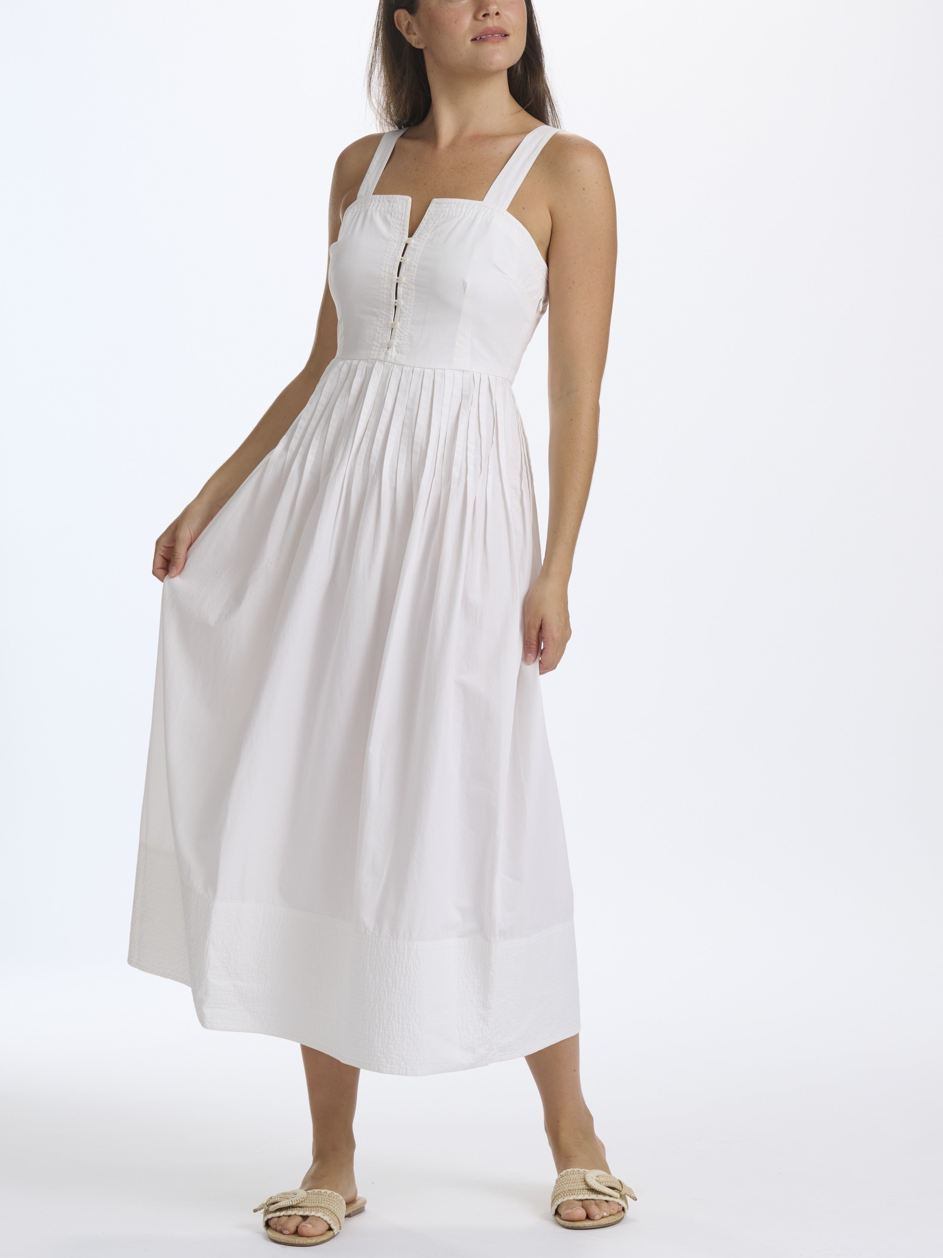 Woman wearing a white dress on a white background