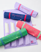 Colorful carrying cases for Oh My! Mahjong sets on a white background