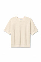 A cream-colored short-sleeve crewneck sweatshirt with raglan sleeves and ribbed cuffs, hem, and collar, displayed flat against a white background.