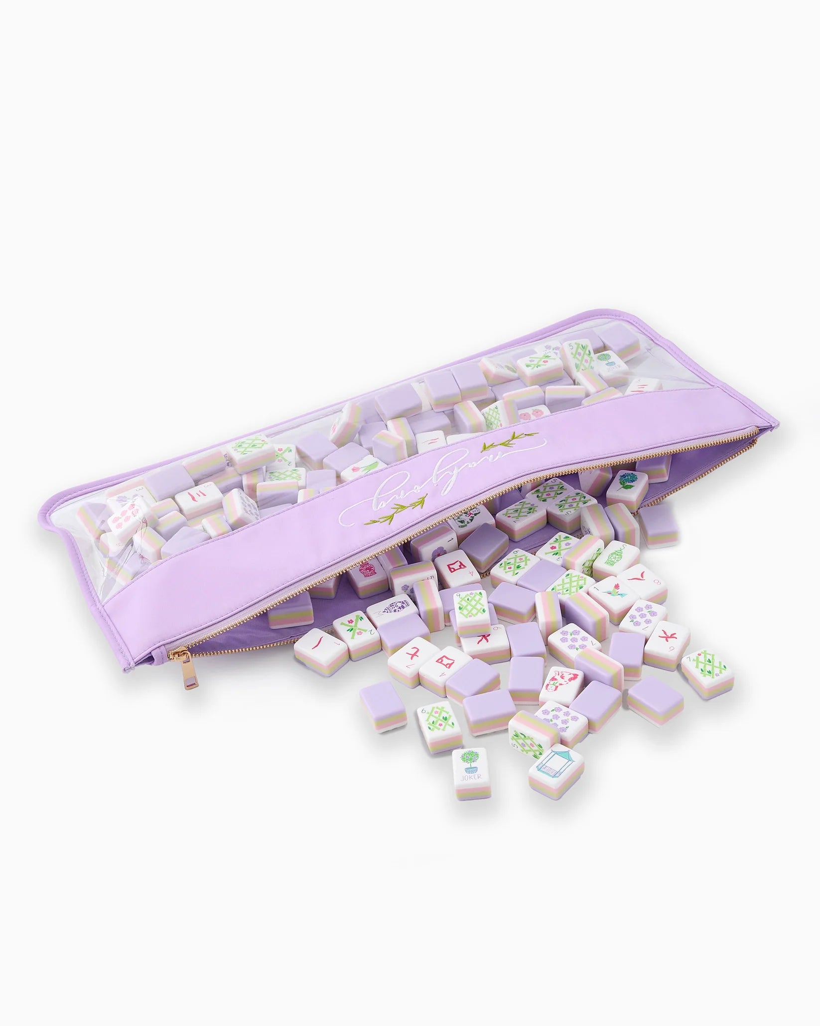 Set of wooden tiles with colorful designs in a purple storage bag on a white background