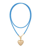 Blue braided necklace with a gold heart pendant on a white background