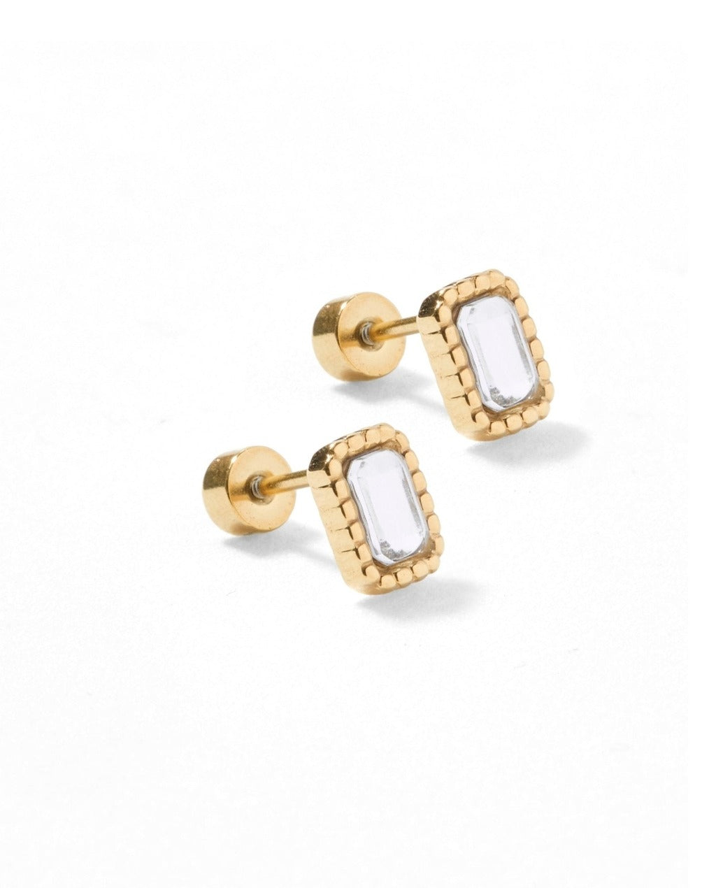 Gold earrings with rectangular clear stones on a white background