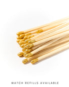 Matches with gold tips on a white background, labeled 'Match Refills Available'.