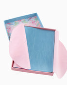 Pink and blue wallet with floral patterned box on a white background