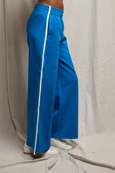 Blue pants with a white stripe on a neutral background