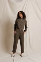 Person wearing a brown tracksuit against a plain background