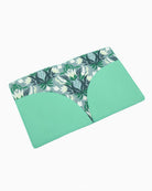 Green placemat with floral pattern on a white background