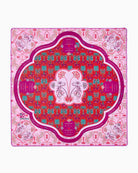 Decorative pink and red patterned tablecloth with central design