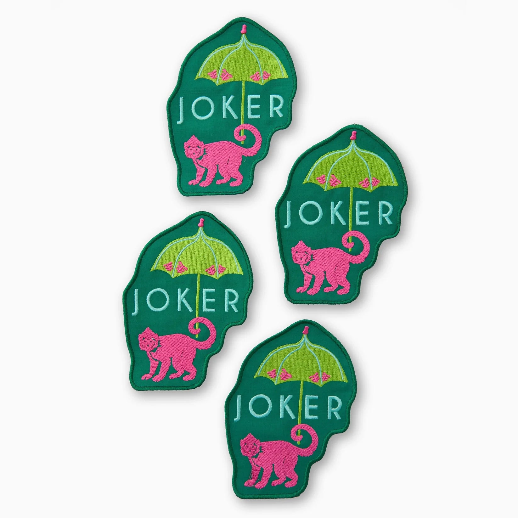 Four green and pink 'Joker' card game piece stickers on a white background