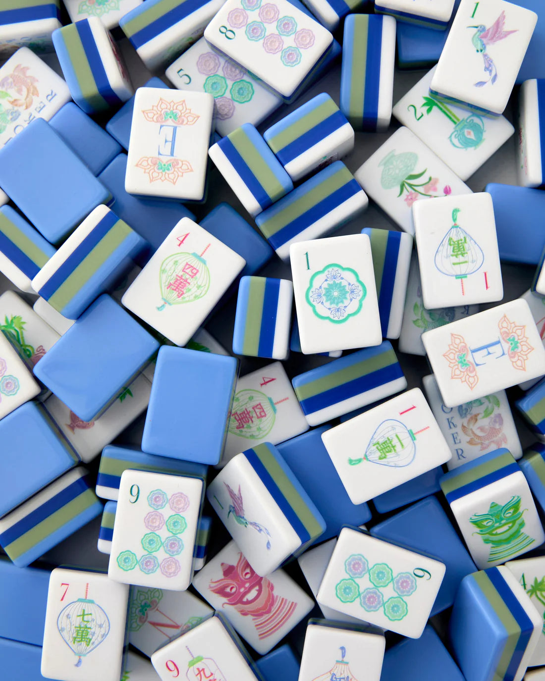 Close-up of blue and white Mahjong tiles with various patterns.