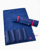 Blue mat with rolled-up mat and pink text on a white background