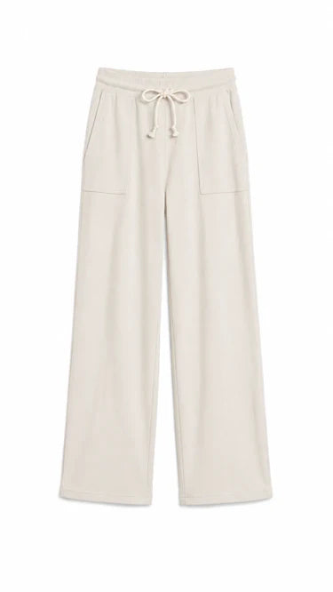 A pair of wide-leg lounge pants in a light cream or off-white color, featuring an elastic waistband with a drawstring and two front patch pockets, shown against a plain white background.
