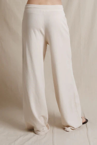 White wide-leg pants on a neutral background