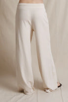 White wide-leg pants on a neutral background
