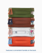 Stack of colorful bags with tassels on a white background
