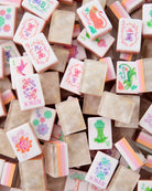 Collection of colorful stamp pads with various designs on a wooden surface