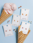 Earring cards with earrings on a blue background with ice cream cones.