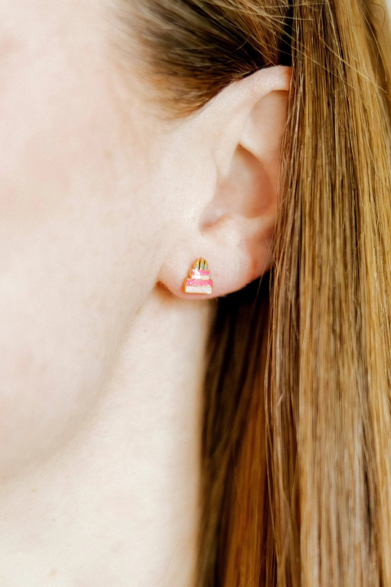 Close-up of an ear wearing a small earring with a blurred background